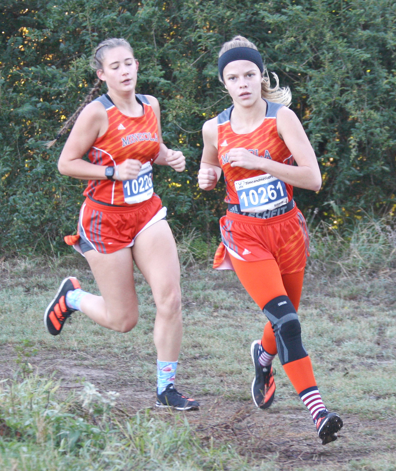 Mineola’s Hannah Zoch (left) finished second, and Juliana Stanley (right) finished third in the girls individual cross country competition last Saturday. The Mineola girls team captured the district crown and will proceed to regionals.
